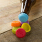 Brightly colored silicone bottle caps ready for use on drinks.