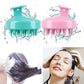 Using the scalp massager shampoo brush to gently scrub and cleanse the scalp.