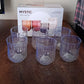Fully transparent heavy-duty plastic glasses in a modern kitchen setting.