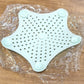 Star shaped silicone sink strainer protecting kitchen sink from hair and debris