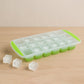 Assortment of flexible silicone ice cube trays in vibrant colors on a white background.