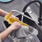 The compact sink caddy shown at its shortest length, fitting smaller sink areas.