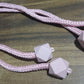 Detailed shot of the durable plastic and pearl elements of the curtain tieback.