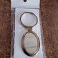Gift-ready packaged oval metal keychain suitable for corporate gifting