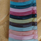 Hand holding plastic banana hair clips showing strong grip design