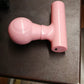 Black mini body massager presented in its retail box packaging.