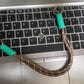A lifestyle image of a person enjoying hands-free convenience with a phone wrist strap attached to their device.