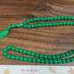 Textural close-up of Muslim prayer beads, highlighting the acrylic material.