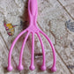 AuriGlam handheld scalp massager shown in its retail packaging.