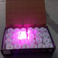 Several pink decorative LED candles creating a cozy atmosphere.
