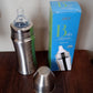 Close-up of the Ganesh stainless steel baby bottle packaging, highlighting key features.