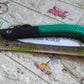 Multi-purpose folding handsaw demonstrating its capability for diverse cutting applications.