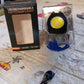 Rechargeable LED keychain flashlight securely attached to a keyring, used outdoors.