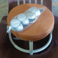 Another view of the white low height rolling stool, emphasizing its compact size.