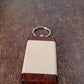 Wooden keychain placed in a lifestyle setting emphasizing natural style and functionality