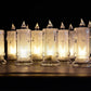 A charming group of Melted Design Flameless Candles casting a warm, inviting glow in a room setting.