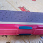 Top view of a cartoon printed pencil case with two organized compartments.