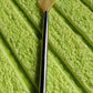 The compact back scratcher displayed neatly in its product packaging.