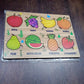 Lifestyle shot showing the wooden fruit puzzle in a child's play area.