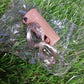 A detailed view of the compact battery compartment within the wine bottle cork.