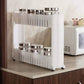 White slim storage rack on wheels, fitting perfectly into a narrow space next to a cabinet.