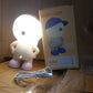 Detail of the easy-to-use button control and stable base of the cartoon LED desk lamp.