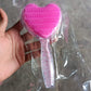 Heart-shaped hair brush displayed with its packaging, illustrating dimensions.