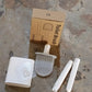 Complete portable toilet brush set with a wall hook accessory.