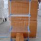 Metallic drying rack with wheels shown in folded position for storage