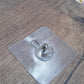 Simple wall hook with a clear adhesive base, ready for quick installation.