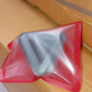 Compact pyramid mobile phone stand placed on desk showing size