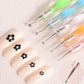 Textured grip on a nail art pen for better handling.