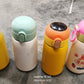 Tidy Table stainless steel water bottle in a vibrant outdoor setting.
