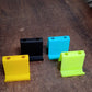 Mixed color mobile phone stand and pen holder placed on wooden table