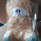 Musical teddy bear plush toy packaged as single gift unit