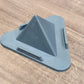 Grey pyramid mobile phone stand placed on office desk