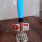 Stainless steel potato masher placed on kitchen counter
