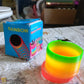 The Rainbow Slinky Toy neatly packaged, ready to be presented as a delightful gift.