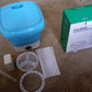 Lifestyle shot of the mini washing machine being used in a small apartment or dorm room.
