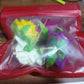 Set of four colorful flower hair pins displayed on neutral background