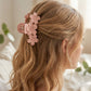Model wearing large pink hair claw clip
