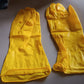 Stack of yellow multi-purpose rubber gloves for home use.