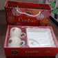 Close-up view of ceramic tea cups and the plastic serving platter in set