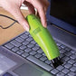 Handheld USB mini vacuum cleaner reaching tight spots in a car dashboard.