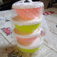 Small plastic bowls with lids placed inside a microwave oven, demonstrating safety.