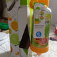 Lifestyle shot of the fruit infuser sports bottle surrounded by fresh citrus fruits and water.