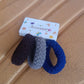 Packaged set of multicolour tyre shape hair bands from Calm & Curl.