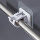 Close-up of wall-mounted adhesive towel rod holder with hanging towels