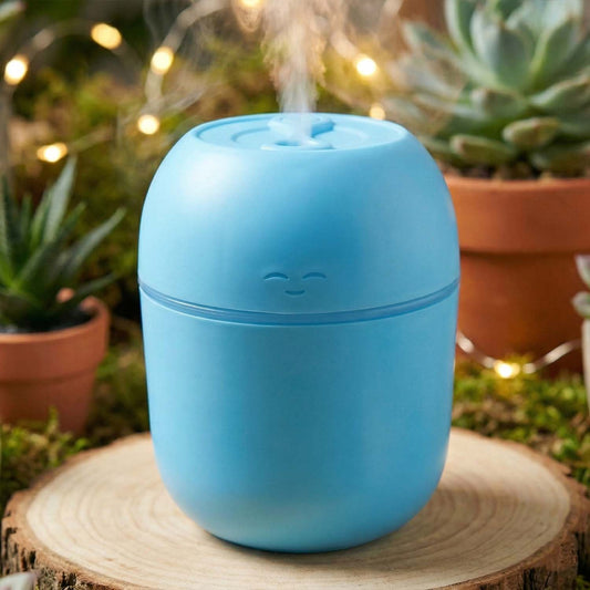 The compact USB Air Humidifier placed on a desk next to a laptop, highlighting its office suitability.