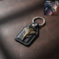 Aircraft design metal keychain with fighter jet emblem on leather-finish base